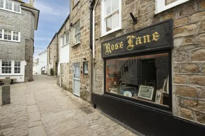a building with a store window on a street at Charming Cottage by the Sea, Wi-Fi, Pets in St Ives