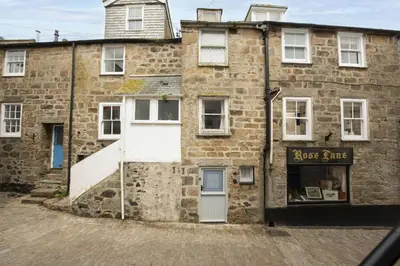 an old brick building with a white door at Charming Cottage by the Sea, Wi-Fi, Pets in St Ives