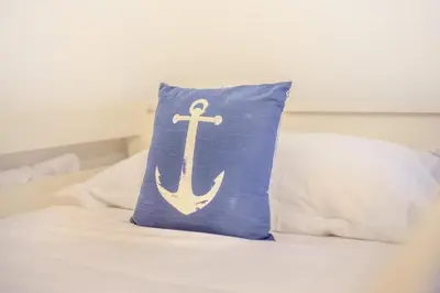 a blue pillow with an anchor on a bed at 2 Bed in Fowey oc-s25324 in Fowey