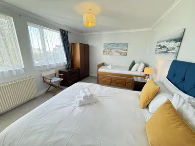 a bedroom with a large white bed in a room at 2 The Links in St Ives
