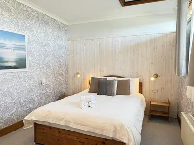 a bedroom with a bed with two towels on it at 2 The Links in St Ives