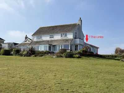 a house on a hill with a large yard at 1 The Links in St Ives