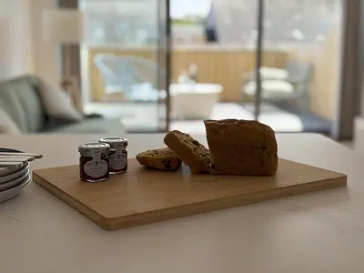 a cutting board with a loaf of bread and two jams at 5 Ayr Court in St Ives