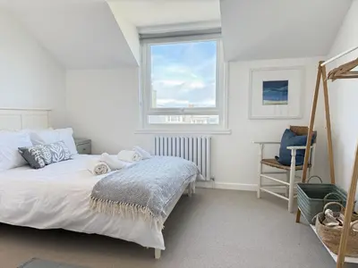 a bedroom with a bed and a window at 5 Ayr Court in St Ives