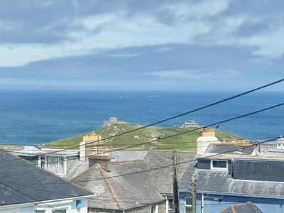 a view of the ocean with houses and roofs at 5 Ayr Court in St Ives