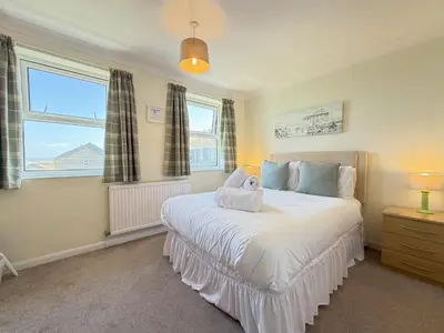 a bedroom with a bed with a stuffed animal on it at Gwel an Mor in St Ives