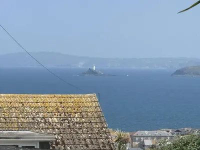 a lighthouse on an island in a body of water at Gwel an Mor in St Ives