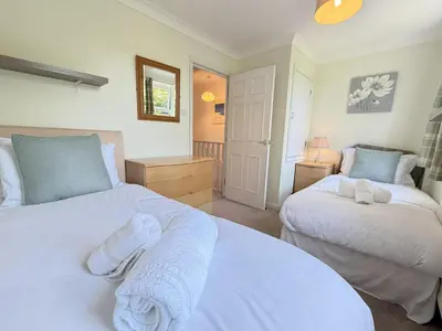 a bedroom with two beds with towels on them at Gwel an Mor in St Ives