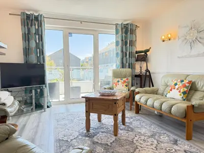 a living room with a couch and a tv at Gwel an Mor in St Ives