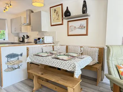 a small kitchen with a table and a kitchen counter at Gwel an Mor in St Ives