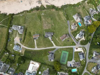 an aerial view of a yard with houses at Headlands- Stylish Oceanfront Property on Harlyn Bay in Padstow
