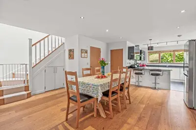 a kitchen and dining room with a table and chairs at House 19 in Looe