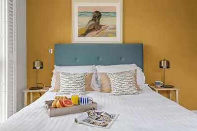 a bed with a tray of food on it at House 21 in Looe