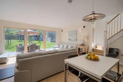 a living room with a couch and a table at House 2 in Looe