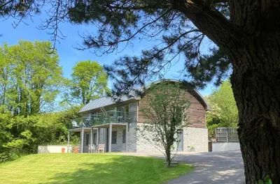 a large brick building with a dome at House 26 in Looe