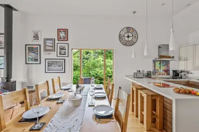 a dining room with a long table and chairs at House 25 in Looe