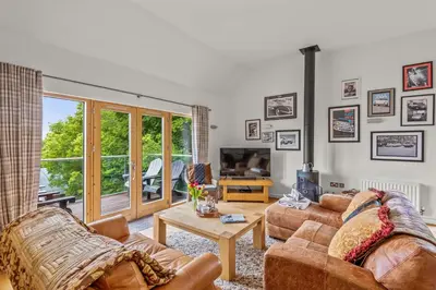 a living room with two couches and a tv at House 25 in Looe