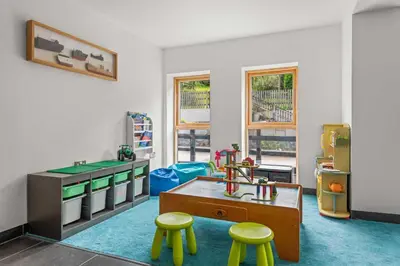 a room with a table and two stools at House 3 in Looe