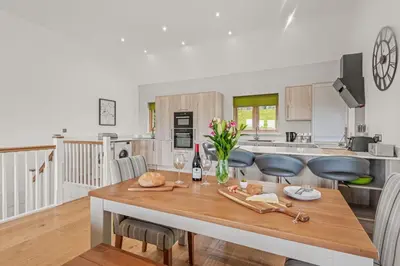 a kitchen and dining room with a table and chairs at House 24 in Talland