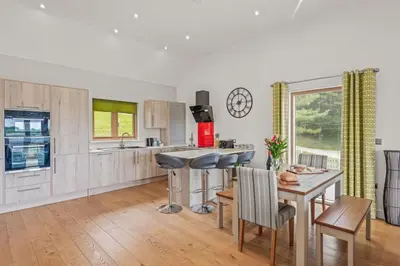 a kitchen with a table and chairs and a dining room at House 24 in Talland