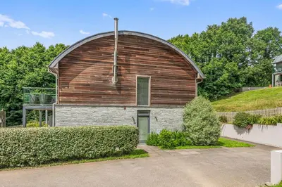 a large wooden barn with a dome on top of it at House 24 in Talland