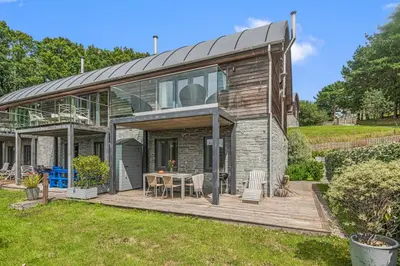 a house with a wooden deck in the yard at House 24 in Talland