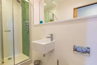 a bathroom with a sink and a shower at House 30 in Looe