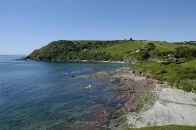 an island in the ocean next to a body of water at House 31 in Looe