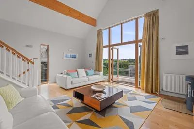 a living room with a couch and a table at House 32 in Looe