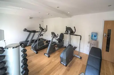 a gym with several exercise bikes in a room at House 34 in Looe