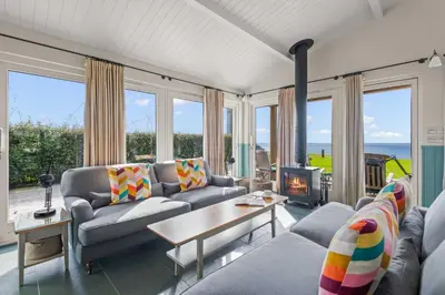 a living room with a couch and a fireplace at House 39 in Looe