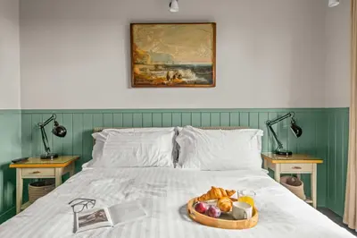 a tray of fruit sitting on top of a bed at House 39 in Looe