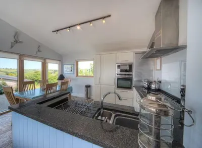 a kitchen with a sink and a counter top at House 38 in Looe