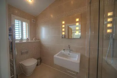a bathroom with a sink and a toilet and a shower at House 38 in Looe
