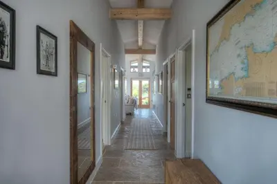 a hallway of a home with a map on the wall at House 38 in Looe