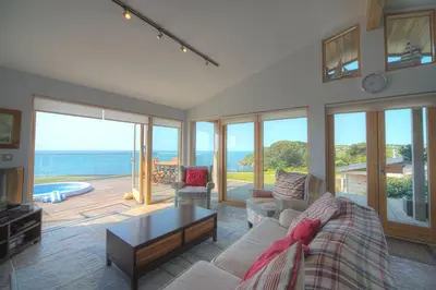 a living room with a couch and a table at House 38 in Looe