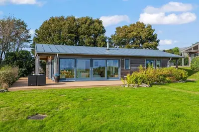 a house with a solar roof on a yard at House 40 in Looe
