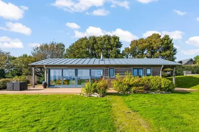 a house with a solar roof on a lawn at House 40 in Looe