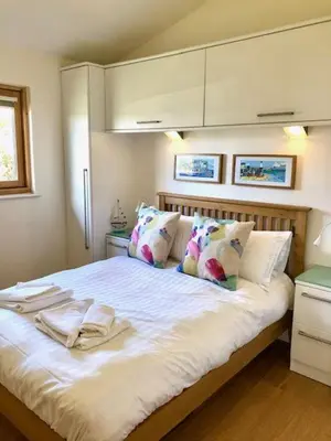 a bedroom with a bed with towels on it at House 41 in Looe