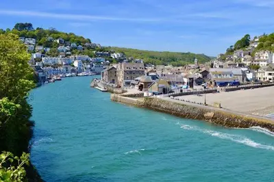 a river next to a beach with houses and a town at House 41 in Looe