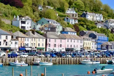 a group of boats docked in a harbor with houses at House 41 in Looe