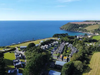 an aerial view of a resort next to the ocean at House 4 in Looe