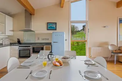 a kitchen with a table with plates and utensils on it at House 36 in Looe