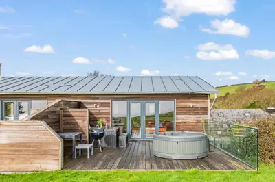 a house with a hot tub on a deck at House 36 in Looe