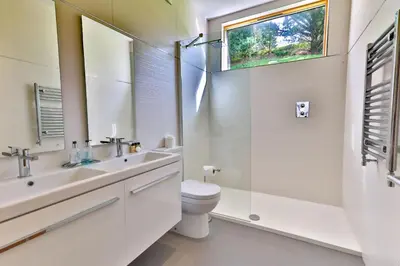 a white bathroom with a sink and a toilet at House 45 in Looe