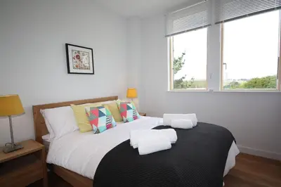 a bedroom with a bed with two towels on it at House 47 in Talland