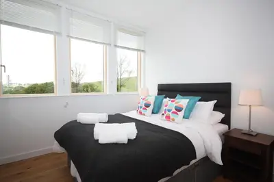 a bedroom with a large bed with pillows at House 47 in Talland