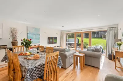 a living room with a table and a couch at House 5 in Looe