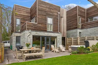 a house with a patio with a table and chairs at House 5 in Looe