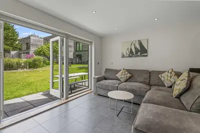a living room with a couch and a table at House 8 in Looe